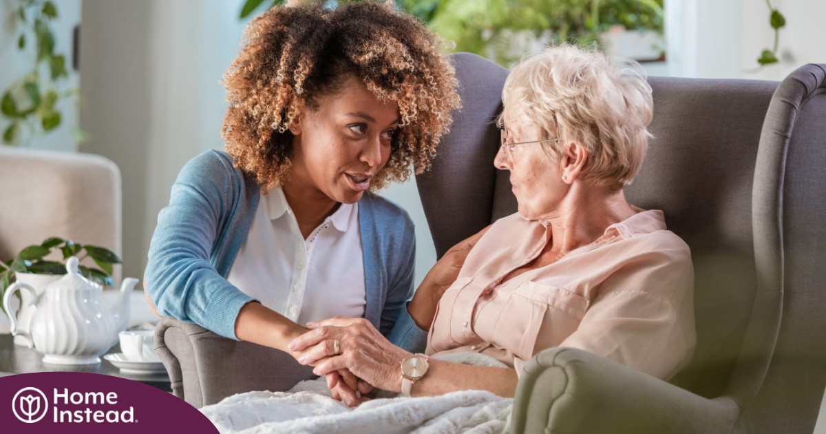 A caregiver warmly reassures an older client, showing the kind of attitude that can help clients get used to new care arrangements.